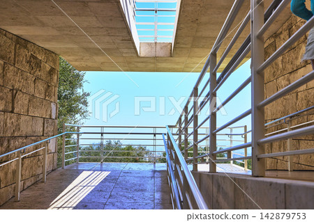 Modern Stone Walkway and Railings with Blue Sky at The Getty Center Los Angeles Modern Stone Walkway and Railings with Blue Sky at The Getty Center Los Angeles 142879753