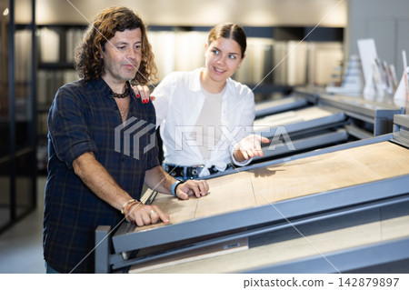 Nice couple in hardware store looking to buy bathroom tiles Nice couple in hardware store looking to buy bathroom tiles 142879897