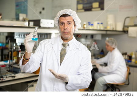 Portrait of an adult male using equipment to work in a laboratory Portrait of an adult male using equipment to work in a laboratory 142879922