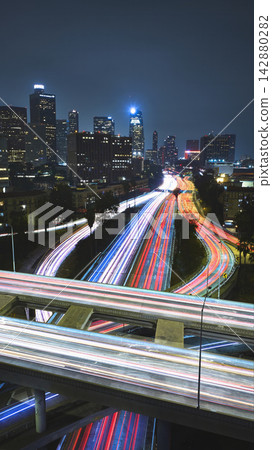 Aerial Los Angeles Spaghetti Highway and The Stack With Car Trails and Skyline 142880282