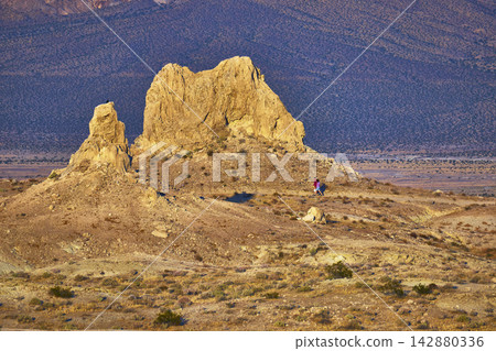 Trona Pinnacles California Desert Hikers and Rocky Formations at Golden Hour Trona Pinnacles California Desert Hikers and Rocky Formations at Golden Hour 142880336