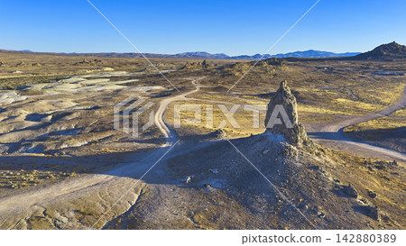 Aerial Trona Pinnacles Tufa Spire and Dirt Road in California Desert Aerial Trona Pinnacles Tufa Spire and Dirt Road in California Desert 142880389