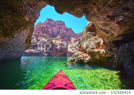 Kayak Enters Emerald Cove Cave On Colorado River With Rocky Canyon And Sunlit Water Kayak Enters Emerald Cove Cave On Colorado River With Rocky Canyon And Sunlit Water 142880424