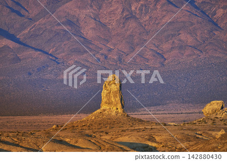 Trona Pinnacles Tufa Spire at Golden Hour with Desert Mountains in California Trona Pinnacles Tufa Spire at Golden Hour with Desert Mountains in California 142880430