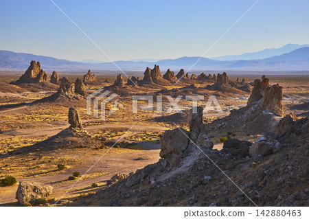 Trona Pinnacles Tufa Spires and Desert Landscape with Distant Mountains California Trona Pinnacles Tufa Spires and Desert Landscape with Distant Mountains California 142880463