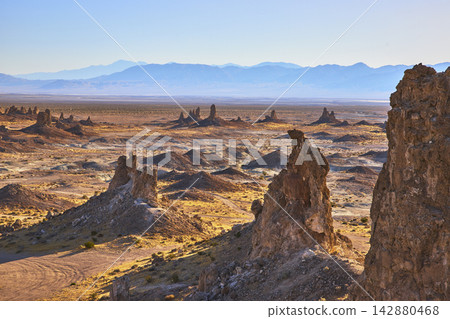 Trona Pinnacles California Desert Rock Formations with Distant Mountains Trona Pinnacles California Desert Rock Formations with Distant Mountains 142880468