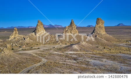 Aerial Trona Pinnacles California Desert Tufa Spires Under Clear Blue Sky Aerial Trona Pinnacles California Desert Tufa Spires Under Clear Blue Sky 142880476
