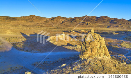 Aerial Trona Pinnacles Sunlit Desert Landscape and Mountain Ridges at Golden Hour Aerial Trona Pinnacles Sunlit Desert Landscape and Mountain Ridges at Golden Hour 142880488