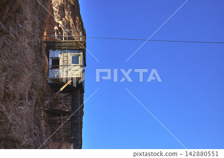 Gauging Station and Cable Tramway on Desert Cliff with Clear Blue Sky 142880551
