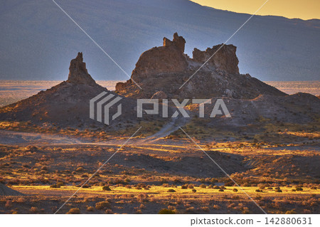 Trona Pinnacles Rock Formations Illuminated by Golden Hour Light in California Desert Trona Pinnacles Rock Formations Illuminated by Golden Hour Light in California Desert 142880631