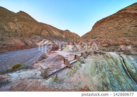 Desert Mining Ruins and Eroded Hills in Nevada Canyon Landscape Desert Mining Ruins and Eroded Hills in Nevada Canyon Landscape 142880677