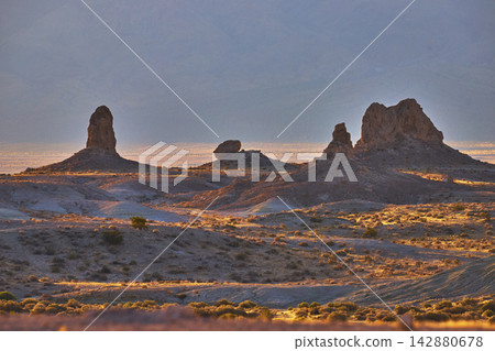 Trona Pinnacles Desert Landscape at Golden Hour with Dramatic Rock Formations Trona Pinnacles Desert Landscape at Golden Hour with Dramatic Rock Formations 142880678