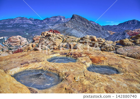 Red Rock Canyon Calico Tanks Pools and Turtlehead Peak Under Bright Blue Sky Red Rock Canyon Calico Tanks Pools and Turtlehead Peak Under Bright Blue Sky 142880740