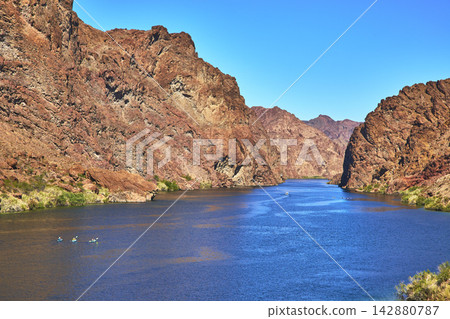 Kayakers on Colorado River Surrounded by Blue Water Willow Beach Arizona Kayakers on Colorado River Surrounded by Blue Water Willow Beach Arizona 142880787