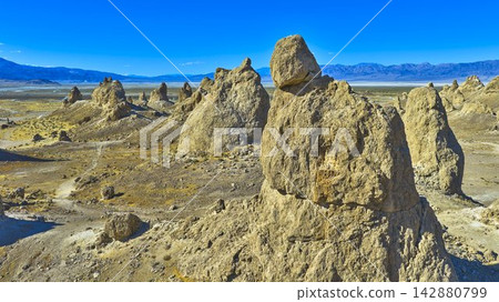 Aerial Trona Pinnacles Tufa Spires and Mojave Desert Landscape under Blue Sky Aerial Trona Pinnacles Tufa Spires and Mojave Desert Landscape under Blue Sky 142880799