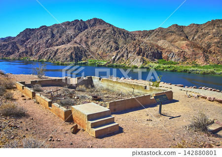 Abandoned Gauging Station Foundation on Colorado River with Arizona Desert Mountains Abandoned Gauging Station Foundation on Colorado River with Arizona Desert Mountains 142880801