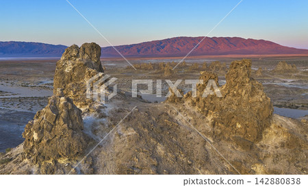 Aerial Trona Pinnacles Geological Formations and Mountains at Golden Hour Aerial Trona Pinnacles Geological Formations and Mountains at Golden Hour 142880838