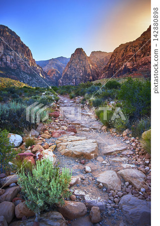 Red Rock Canyon Trail at Sunset with Pine Creek Cliffs and Desert Vegetation 142880898