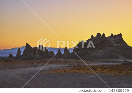 Trona Pinnacles California Desert Spires at Golden Hour with Distant Mountains Trona Pinnacles California Desert Spires at Golden Hour with Distant Mountains 142880959