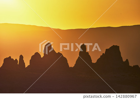 Trona Pinnacles Silhouette at Golden Hour with Vibrant Desert Sky California Trona Pinnacles Silhouette at Golden Hour with Vibrant Desert Sky California 142880967