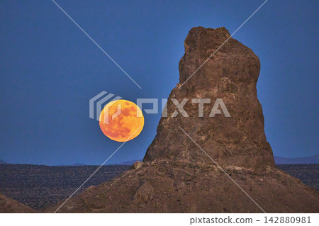 Trona Pinnacles California Desert Spire with Full Moon at Night Trona Pinnacles California Desert Spire with Full Moon at Night 142880981