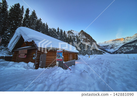 Winter Cabin and Pine Forest by Snowy Lake Louise with Rocky Mountains Winter Cabin and Pine Forest by Snowy Lake Louise with Rocky Mountains 142881090