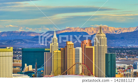 Aerial Las Vegas Strip New York New York Hotel Towers at Sunset with Mountain Backdrop Aerial Las Vegas Strip New York New York Hotel Towers at Sunset with Mountain Backdrop 142881127
