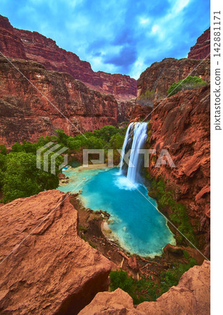 Havasu Falls Vibrant Blue Pool and Red Canyon Walls in Arizona Supai Region 142881171