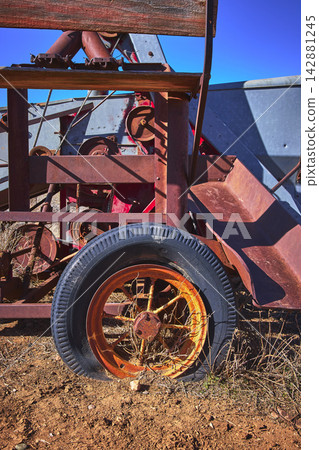 Rusty Wheel and Abandoned Farm Equipment Close Up in Arizona Desert Rusty Wheel and Abandoned Farm Equipment Close Up in Arizona Desert 142881245