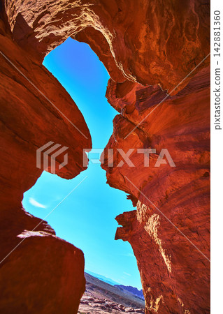 Red Sandstone Formations with Blue Sky and Distant Desert Landscape Red Sandstone Formations with Blue Sky and Distant Desert Landscape 142881360