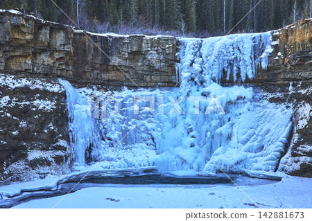 Frozen Crescent Falls Winter Waterfall and Rocky Cliff Face in Alberta 142881673