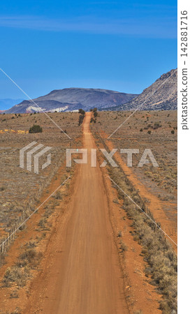 Arizona Strip Dirt Road Leading to Mount Trumbull in Rugged Desert Landscape 142881716