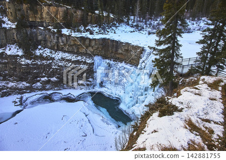 Frozen Waterfall and Snowy Cliffs at Crescent Falls in Winter Forest Landscape Frozen Waterfall and Snowy Cliffs at Crescent Falls in Winter Forest Landscape 142881755
