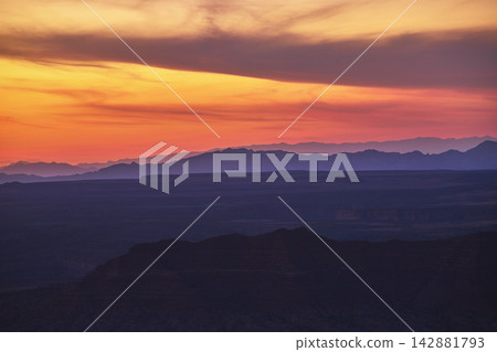 Grand Canyon Layers and Vibrant Sunset Sky Over Desert Mountains Grand Canyon Layers and Vibrant Sunset Sky Over Desert Mountains 142881793