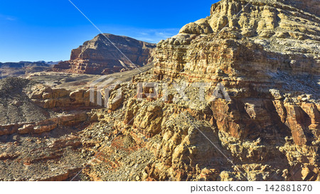 Aerial Rugged Cliffs and Canyon Landscape with Sunlit Rock Formations Aerial Rugged Cliffs and Canyon Landscape with Sunlit Rock Formations 142881870