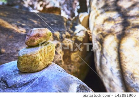 Rock Stack and Cairn with Sunlit Boulder Textures in Tranquil Canyon Rock Stack and Cairn with Sunlit Boulder Textures in Tranquil Canyon 142881900