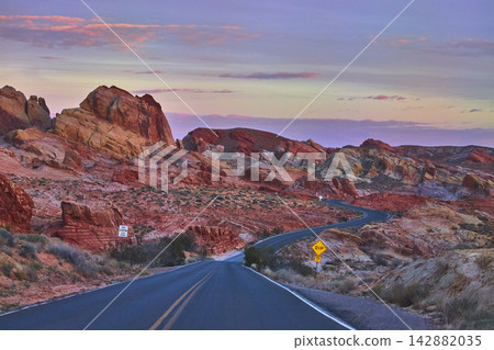 Winding Road and Colorful Rock Formations at Sunrise in Valley of Fire Nevada Winding Road and Colorful Rock Formations at Sunrise in Valley of Fire Nevada 142882035