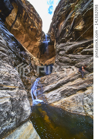 Waterfall and Winter Pool in Red Rock Canyon Nevada with Hiker and Dramatic Cliffs Waterfall and Winter Pool in Red Rock Canyon Nevada with Hiker and Dramatic Cliffs 142882098