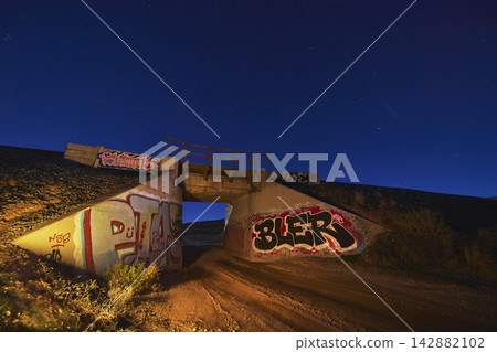 Graffiti Covered Overpass and Starry Blue Hour Sky at Jean Dry Lake Bed Nevada Graffiti Covered Overpass and Starry Blue Hour Sky at Jean Dry Lake Bed Nevada 142882102