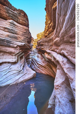 Slot Canyon Rock Formations and Water Pool in Sunlight 142882290