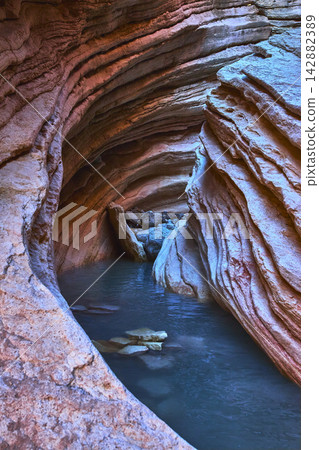 Slot Canyon Water Pools and Layered Rock Formations in Colorful Desert Light Slot Canyon Water Pools and Layered Rock Formations in Colorful Desert Light 142882389
