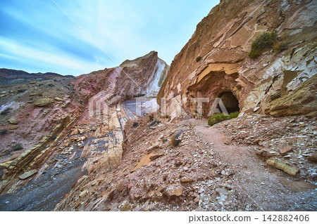 Anniversary Mine Tunnel and Dramatic Rock Formations in Nevada Desert Landscape Anniversary Mine Tunnel and Dramatic Rock Formations in Nevada Desert Landscape 142882406