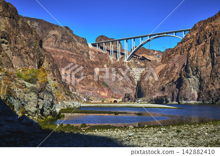 Colorado River Bridge and Rocky Canyon Walls with Water in Nevada Colorado River Bridge and Rocky Canyon Walls with Water in Nevada 142882410