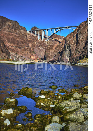 Bridge Over Colorado River With Rocky Canyon And Water Reflection Nevada Bridge Over Colorado River With Rocky Canyon And Water Reflection Nevada 142882411