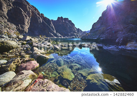 Goldstrike Hot Spring Pool and Rocky Canyon with Sunlight Reflection and Clear Water 142882460