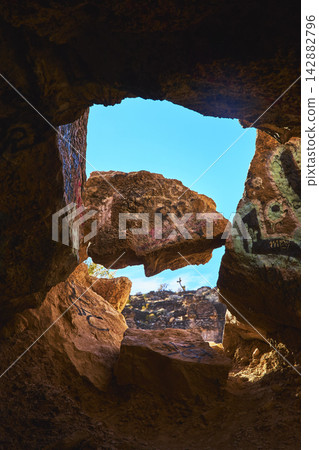 Cave Interior with Graffiti and Sunlit Rock Opening in Cowboy Canyon Nevada Cave Interior with Graffiti and Sunlit Rock Opening in Cowboy Canyon Nevada 142882796
