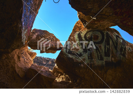 Graffiti Covered Cave Interior Sunlit Red Rock Cowboy Canyon Nevada Graffiti Covered Cave Interior Sunlit Red Rock Cowboy Canyon Nevada 142882839