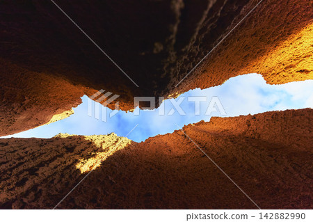 Slot Canyon Walls and Blue Sky Contrast in Cathedral Gorge State Park Nevada Slot Canyon Walls and Blue Sky Contrast in Cathedral Gorge State Park Nevada 142882990