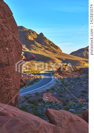 Winding Road and Redstone Dunes at Sunrise in Nevada Desert Landscape Winding Road and Redstone Dunes at Sunrise in Nevada Desert Landscape 142883074