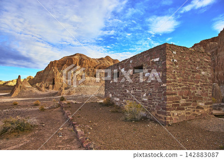 Abandoned Stone Building and Dramatic Cliffs in Desert Landscape Cathedral Gorge 142883087